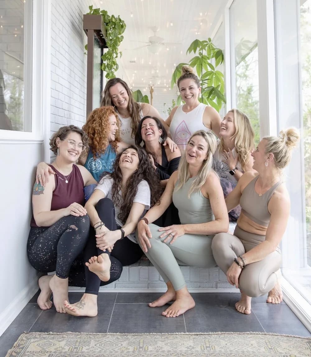 A group sitting together on the sunroom steps after a class.